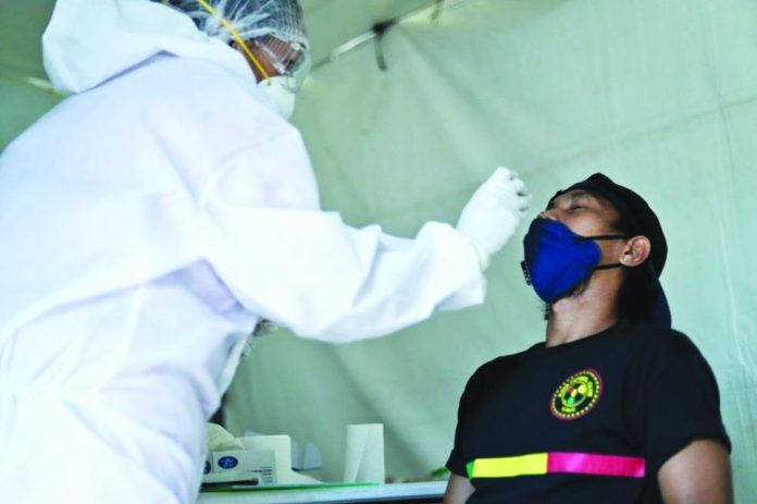 Specimen is being extracted from a Kaya Futbol Club-Iloilo player for coronavirus disease 2019 testing. KAYA ILOILO PHOTO