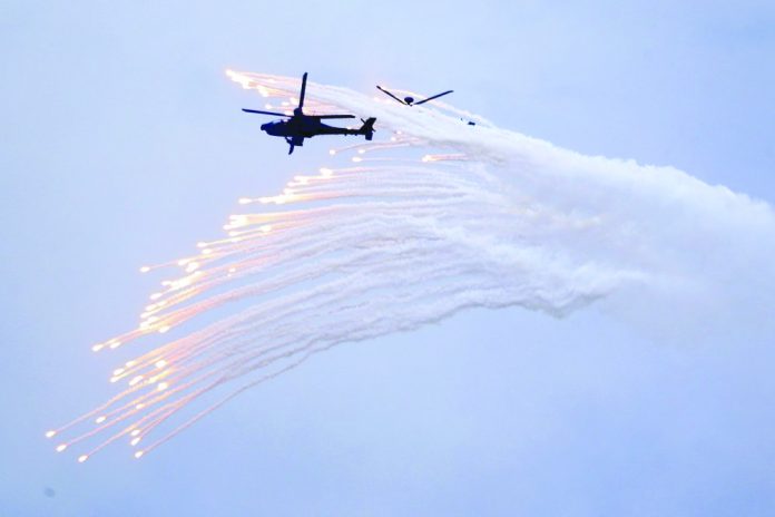 Taiwan's AH-64E Apache attack helicopter launches flares during the 36th Han Kung military exercises in Taichung City, central Taiwan on July 16, 2020. AP PHOTO/CHIANG YING-YING