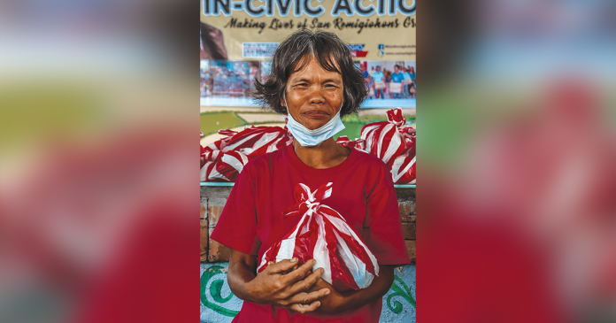 This resident of Barangay Cabunga-an, San Remigio, Antique avails herself of a food pack provided by the municipal government on July 23. Cabunga-an is a far-flung barangay which could only be reached by walking on foot for about three hours starting from San Rafael, the nearest village. SAN REMIGIO OFFICIAL FB PAGE