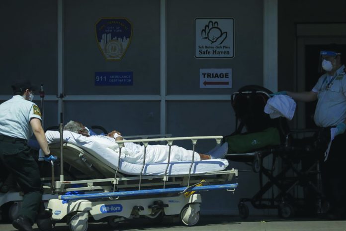 A patient is brought by ambulance to the Maimonides Medical Center in Brooklyn, May 4, 2020. In New York City, the daily onslaught of death from the coronavirus has dropped to half of what it was, much of the country remains in the firm grip of a pandemic with little hope of release. THE NEW YORK TIMES