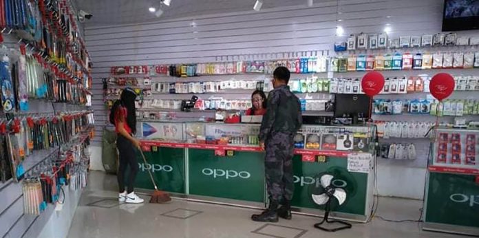 A police officer inspects a business establishment in Jordan, Guimaras. Based on Executive Order No. 47 of Mayor Ruben Corpuz, all business establishments in the municipality except for health facilities and funeral parlors are only allowed to open not earlier than 6 a.m. and close not later than 6 p.m. JORDAN MPS GUIMARAS