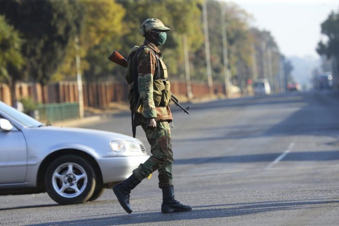 Armed soldiers patrol a street in Harare, Friday, July, 31, 2020. Zimbabwe's capital, Harare, was deserted yesterday as security agents vigorously enforced the country's lockdown amidst planned protests. AP