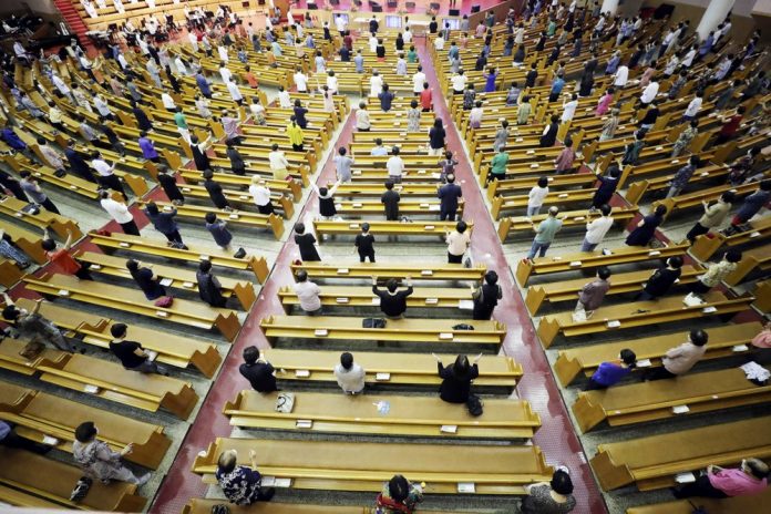 Christians wearing face masks while maintaining social distancing attend a service at the Yoido Full Gospel Church in Seoul, South Korea, Sunday, Aug. 16, 2020. CHOI JAE-GOO/YONHAP VIA AP