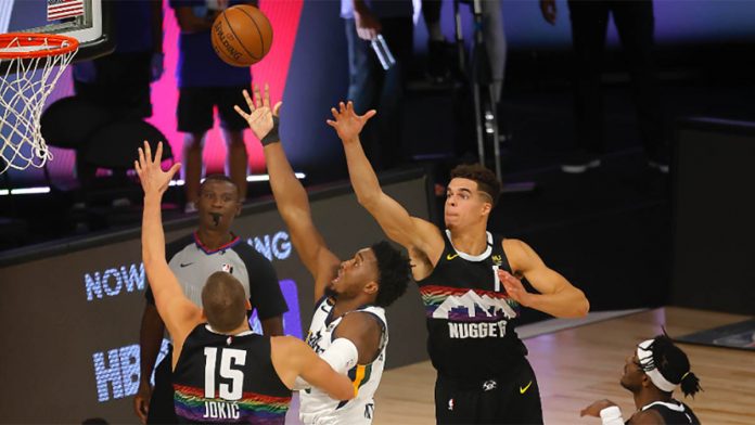 Donovan Mitchell #45 of the Utah Jazz drives to the basket against Nikola Jokić #15 of the Denver Nuggets during the second quarter in Game Five of the Western Conference first round playoffs in Lake Buena Vista, Florida on August 25, 2020. GETTYIMAGES