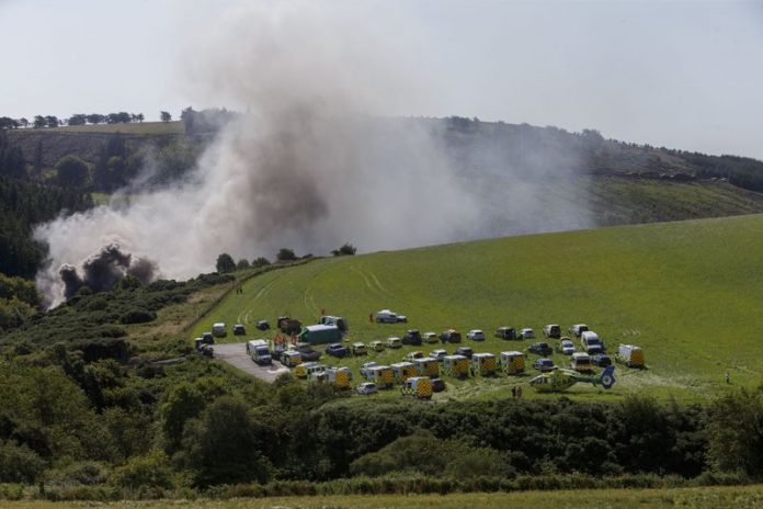 Emergency services attend the scene of a derailed train in Stonehaven, Scotland, Wednesday Aug. 12, 2020. ROSS JOHNSTON/NEWSLINE-MEDIA VIA AP