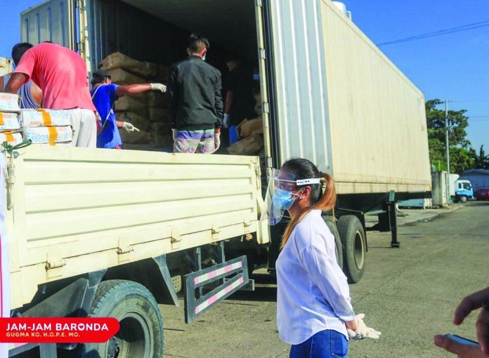 Iloilo City’s Cong. Julienne “Jam-jam” Baronda checks the boxes of frozen fish she facilitated for distribution to poor households in the metro. The recent temporary closure of the Iloilo Fish Port and public markets due to the surge in coronavirus cases has made difficult the people’s access to fish.