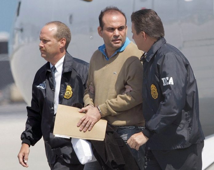 In this May 13, 2008 file photo, Colombian paramilitary warlord Salvatore Mancuso is escorted by U.S. DEA agents upon his arrival to Opa-locka, Florida. AP