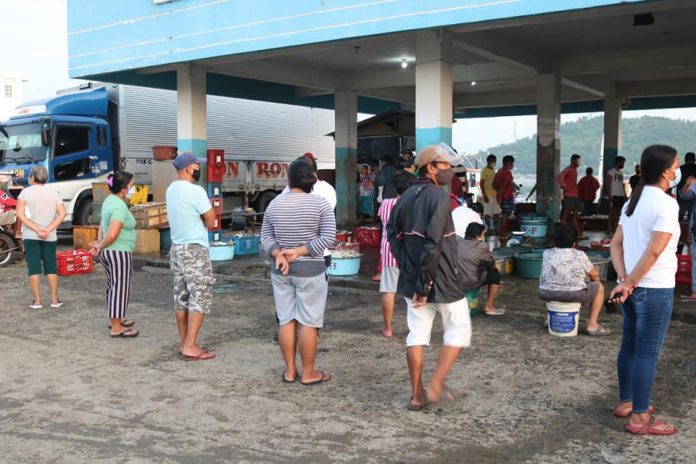 Individuals wear facemasks and observe social distancing while queuing at the Libas Fishing Port in Roxas City, Capiz in this undated photo. The office of the fishing port is on lockdown until further notice after one of its workers tested positive for coronavirus disease 2019. UPOD KITA RONNIE DADIVAS FB