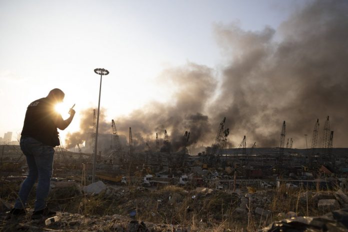 Aftermath of a massive explosion is seen in in Beirut, Lebanon, Tuesday, Aug. 4, 2020. Massive explosions rocked downtown Beirut on Tuesday, flattening much of the port, damaging buildings and blowing out windows and doors as a giant mushroom cloud rose above the capital. Witnesses saw many people injured by flying glass and debris. (AP Photo/Hassan Ammar)