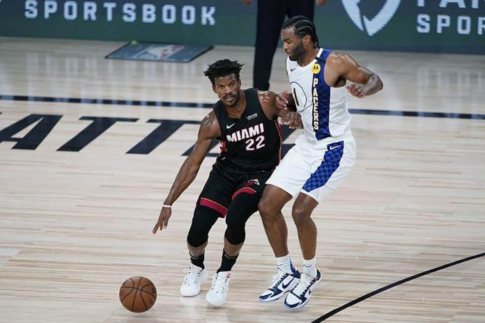 Miami Heat’s Jimmy Butler scouts for teammates to pass the ball to while India Pacers’ T.J. Warren defends him during Game 3 of the two teams’ NBA playoff series on Saturday (Sunday in the Philippines). SPORTSKEEDA