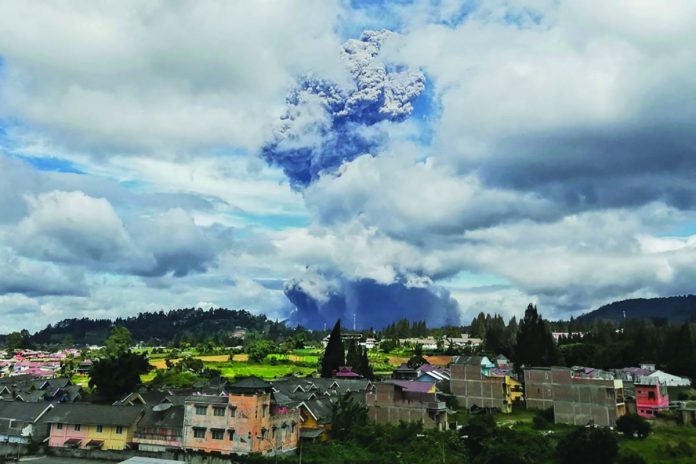 Mount Sinabung spews volcanic materials into the air as it erupts, in Karo, North Sumatra, Indonesia, Monday. AP