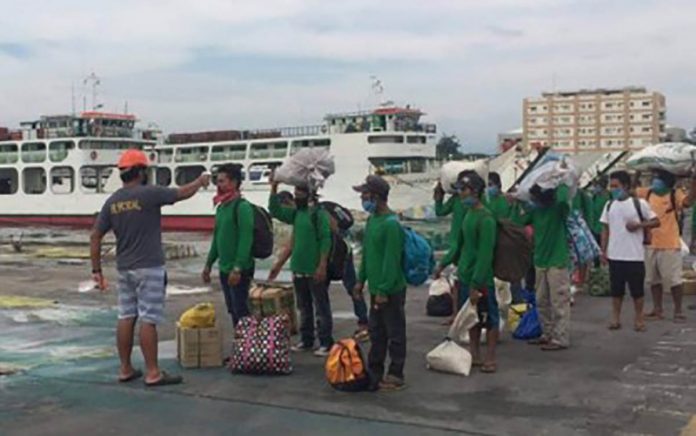 Some stranded “sacadas” or migrant sugar workers in Negros Occidental wait to board a vessel at the Bredco port to travel back home to Panay in this photo taken last May. Travel and health protocols have been set for their return to Negros Occidental in time for the start of the milling season in September. ADRIAN BOBE VIA PNA