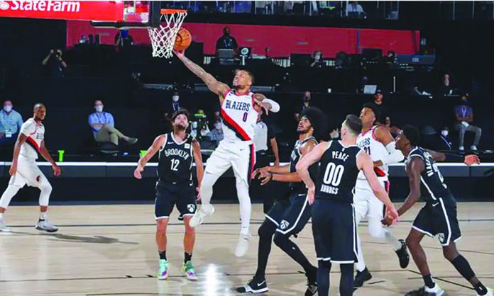 Damian Lillard of the Portland Trail Blazers soars to the rim against the Brooklyn Nets on Thursday night. Portland will play ninth-seeded Memphis on Sunday for the no. 8 seed in Western Conference. GETTY IMAGES