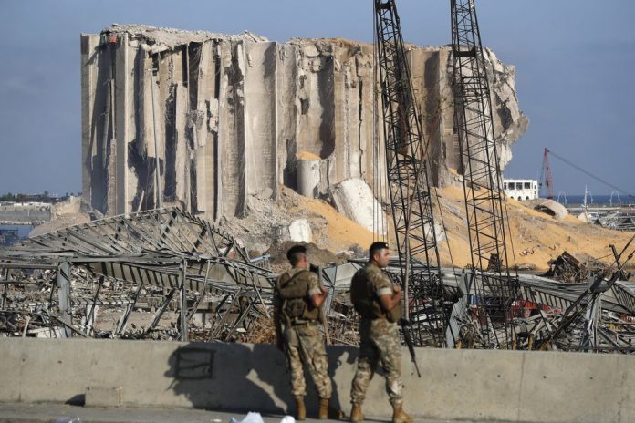 In this Aug. 6, 2020 file photo, Lebanese army soldiers stand guard at the scene where an explosion hit on Tuesday the seaport of Beirut, Lebanon. AP/HUSSEIN MALLA