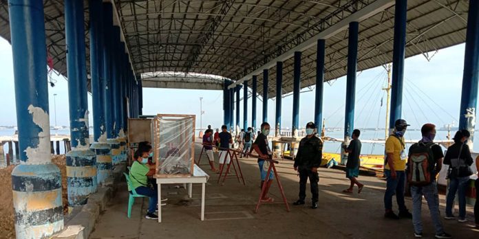 A police officer guards the wharf in Buenavista, Guimaras on Aug. 11. Protocols at the wharves in Guimaras have been tightened to avoid the spread of COVID-19 in the island province. BUENAVISTA MPS GUIMARAS PROVINCE