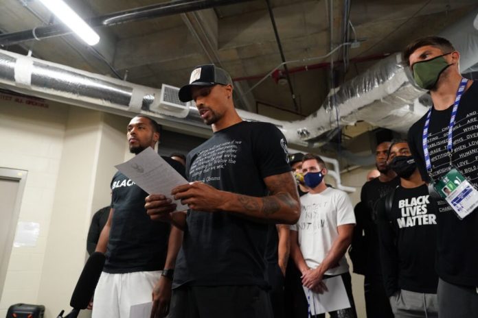 Milwaukee Bucks guard George Hill reads the official statement of the team boycotting Game 5 of their National Basketball Association playoffs against the Orlando Magic on Wednesday. GETTY IMAGES