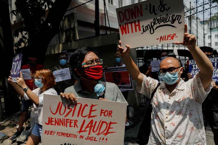 Members of an LGBTQ+ group protest the early release of United States Lance Corporal Joseph Scott Pemberton, who was convicted of killing Filipino transgender woman Jennifer Laude, outside the Department of Justice in Manila on Sept. 3, 2020. REUTERS