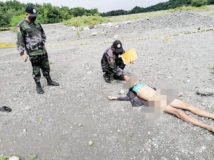 Responding policemen inspect the body of Bonifacio Pacete. He was found dead with no undergarments in a river at Sitio Iglunoy, Barangay Bagtason, Bugasong, Antique around 8:45 a.m. on Sept. 16. BUGASONG MPS/ ANTIQUE PPO