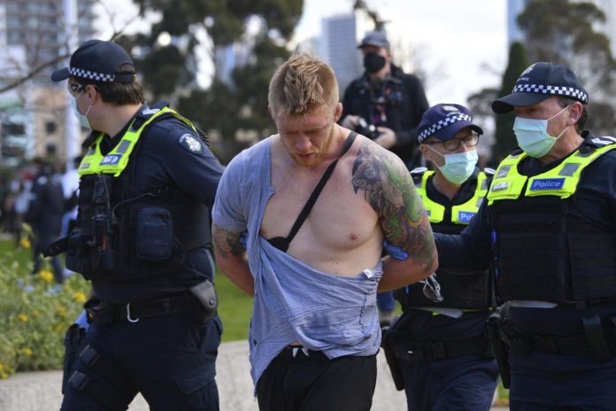 Police arrest a man as people gather at so-called “Freedom Day” protest in Melbourne on Sept. 5, 2020. JAMES ROSS