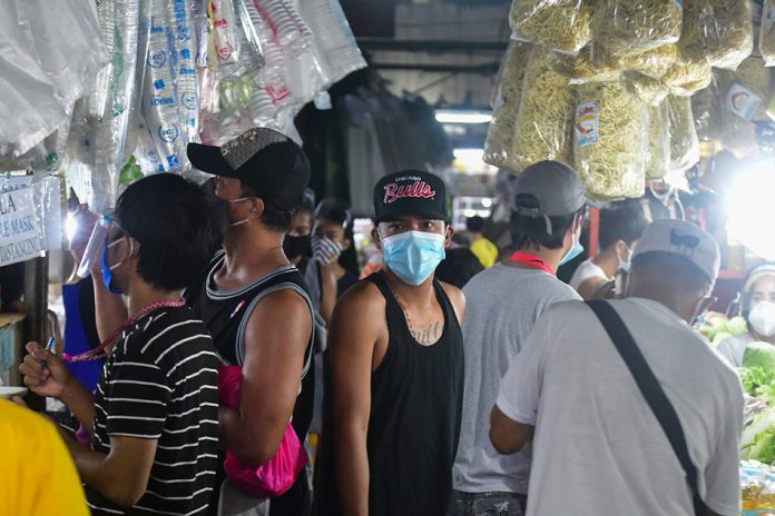 Market-goers shop inside a market in Quezon City on Aug. 26, 2020, amid the general community quarantine. ABS-CBN