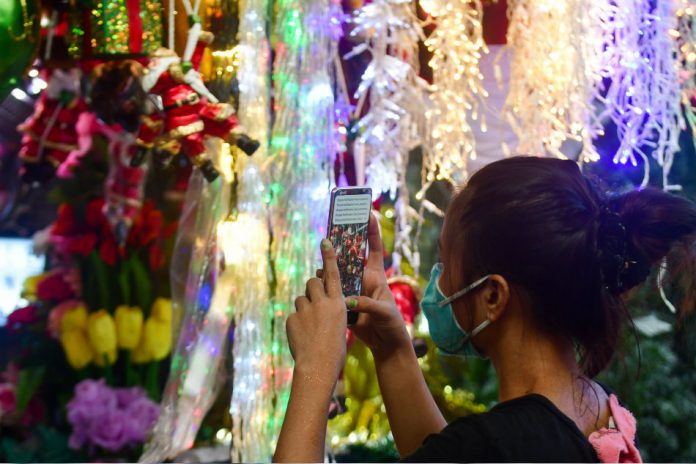 A stall in Quezon City utilizes various online platforms to sell various Christmas decor on Sept. 1, 2020. The stall has turned to online selling to cope with the low physical store sales due to the pandemic. ABS-CBN