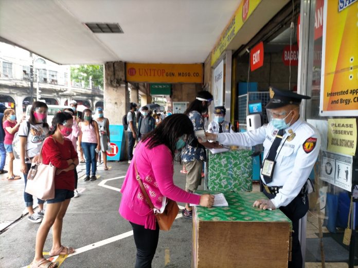 Before entering business establishments such as this one in Iloilo City, customers have to fill out a health declaration form. They must also submit to a body temperature check and observe physical distancing (at least one meter) while queuing. IAN PAUL CORDERO/PN