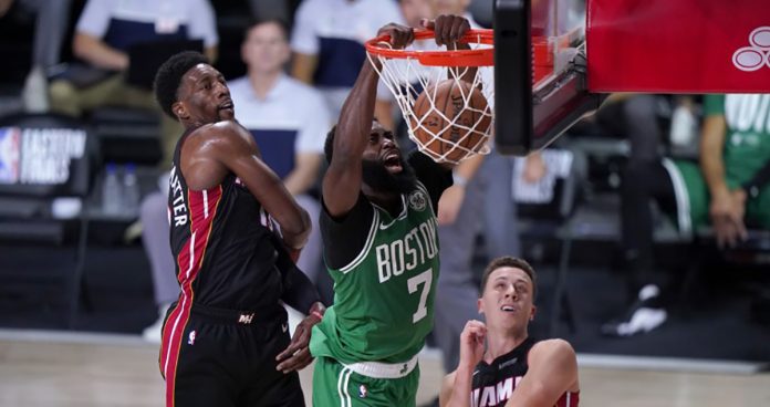 Boston guard Jaylen Brown dunks over Miami Heat’s Bam Adebayo (left) and Duncan Robinson during the second half of the Celtics’ win in Game 3 of the Eastern Conference finals on Saturday (Sunday in the Philippines). PHOTO COURTESY OF MARK J. TERRILL/AP