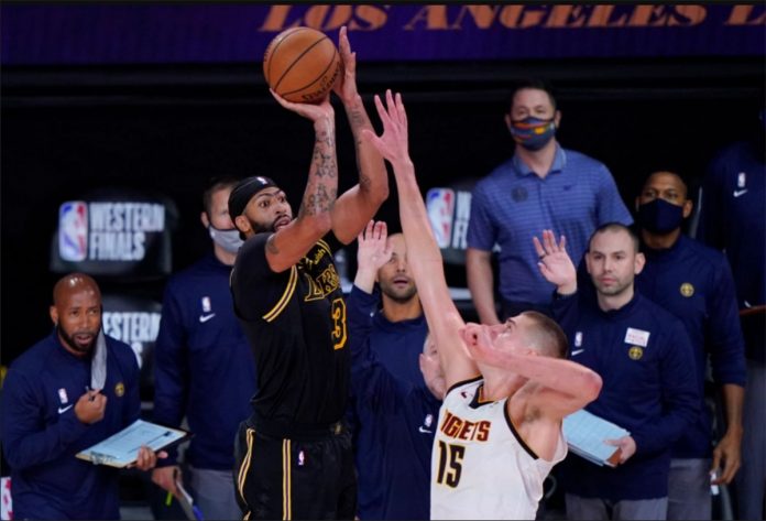 Los Angeles Lakers’ Anthony Davis drains a game-winning triple over Denver Nuggets’ Nikola Jokić in Game 2 of their Western Conference finals on Sunday in Lake Buena Vista, Florida. PHOTO COURTESY OF MARK TERILL/AP