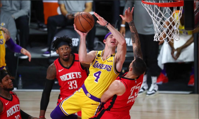 Los Angeles Lakers’ Alex Caruso attacks the defense of Houston Rockets’ Austin Rivers for an inside hit. USA TODAY PHOTO