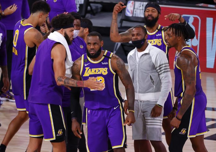 LeBron James celebrates with Los Angeles Lakers teammates after their Game 5 win against Denver Nuggets. PHOTO COURTESY OF KEVIN C. COX/GETTY IMAGES