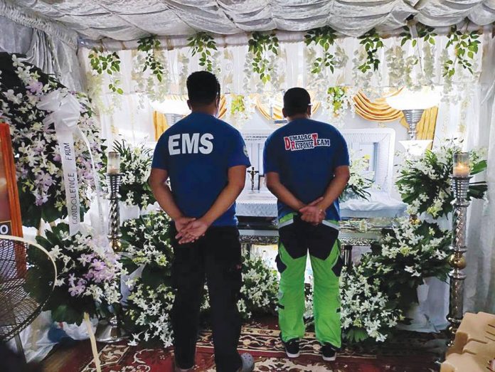 Members of the Municipal Disaster Risk Reduction and Management Office of Sigma, Capiz pay last respects to their coworker Ernie Fulgencio who died in a road accident on Sept. 7. SIGMA LGU