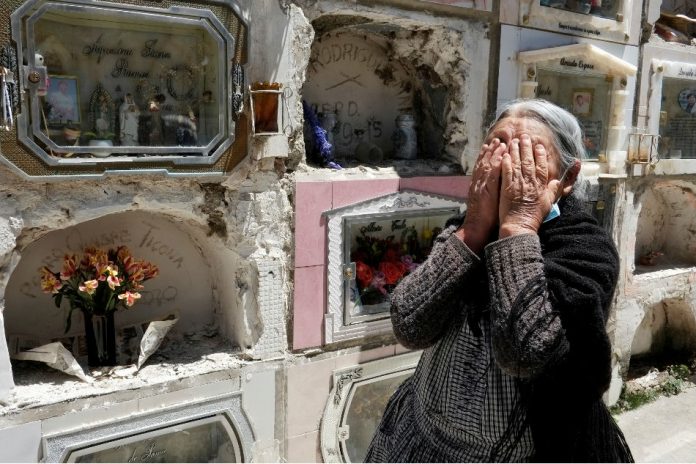 A woman reacts next to the grave of her husband as the General Cemetery was reopened for visitors in La Paz, Bolivia. DAVID MERCADO, REUTERS