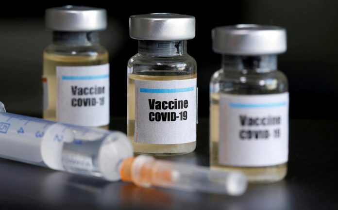 Small bottles labeled with a “Vaccine COVID-19” sticker and a medical syringe are seen in this illustration taken taken April 10, 2020. REUTERS