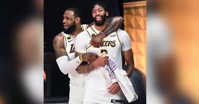 LeBron James (left) and Anthony Davis celebrate in the closing moments of Game 6 of the NBA Finals as the Lakers win their 17th championship. WALLY SKALIJ/LOS ANGELES TIMES