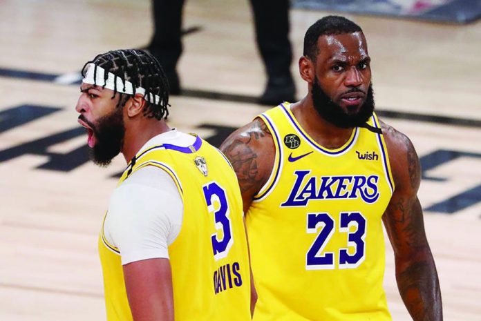 LeBron James and Anthony Davis of the Los Angeles Lakers react during Game 1 of the NBA Finals on September 30, 2020 at the AdventHealth Arena at ESPN Wide World Of Sports Complex in Orlando, Florida. ERIK S. LESSER/EPA-EFE