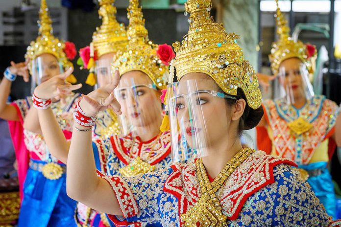 Traditional Thai dancers wearing protective face shields perform at the Erawan Shrine, which was reopened after the Thai government relaxed measures to combat the spread of the novel coronavirus, in Bangkok on May 4, 2020. AFP