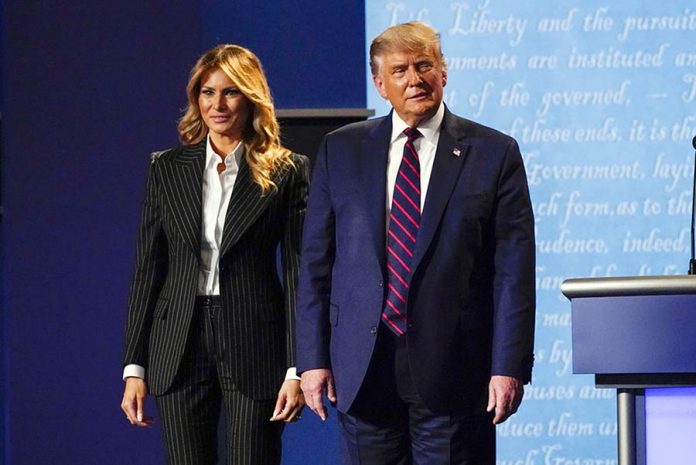 President Donald Trump stands on stage with first lady Melania Trump after the first presidential debate with Democratic presidential candidate former Vice President Joe Biden on Sept. 29, 2020, at Case Western University and Cleveland Clinic, in Cleveland, Ohio. Trump and his first lady have tested positive for the coronavirus, the president tweeted early Friday. AP