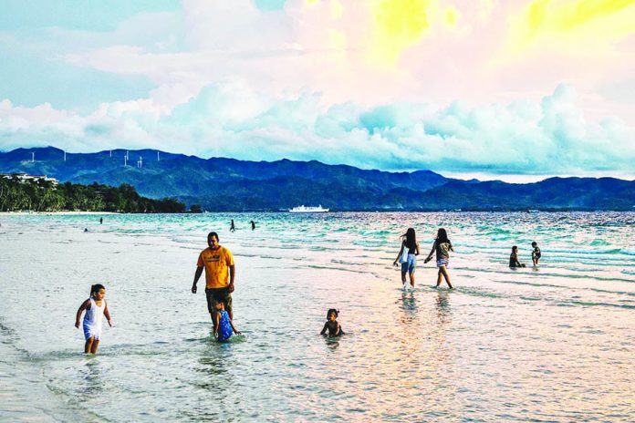 Several tourists are spotted in the waters of Boracay Island in Malay, Aklan days after its re-opening on Oct. 1. The famed-island resort was shut down for four months due to the coronavirus pandemic. EZRA ACAYAN/GETTY IMAGES