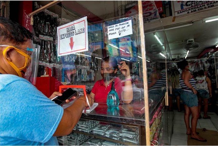 Customers provide contact details for contact tracing before being entertained at a shop selling beauty products in Caloocan City. JONATHAN CELLONA/ABS-CBN NEWS