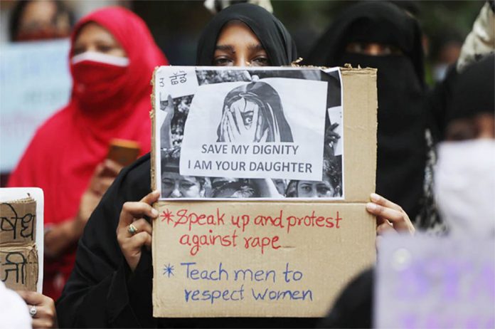 Women hold placards during a protest after the death of a rape victim, on a street in Mumbai, India, Oct. 6, 2020. FRANCIS MASCARENHAS/REUTERS