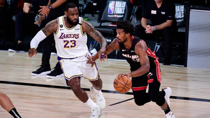 Miami Heat’s Jimmy Butler attacks the defense of Los Angeles Lakers’ LeBron James. NBA PHOTO