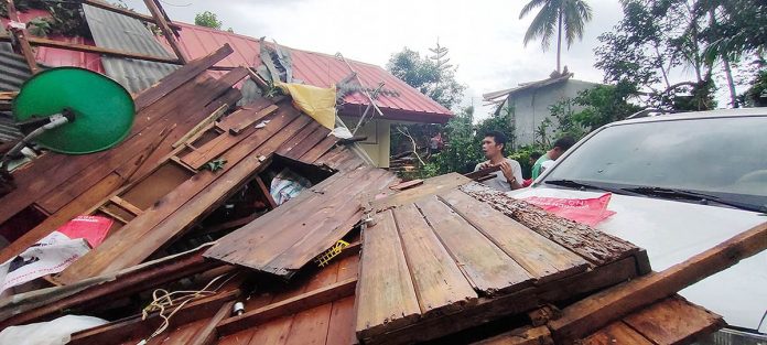 Residents salvage what they could from the rubble of their houses after a tornado tore through Barangay Minapasok in Calatrava, Negros Occidental Tuesday afternoon. HAR RIS MOJELLO