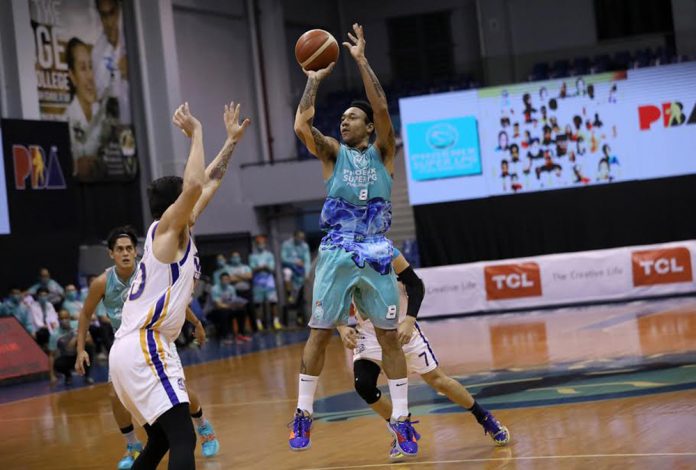 Phoenix Super LPG Fuel Masters’ Calvin Abueva shoots over the defense of NLEX Road Warriors’ William McAloney. PBA PHOTO