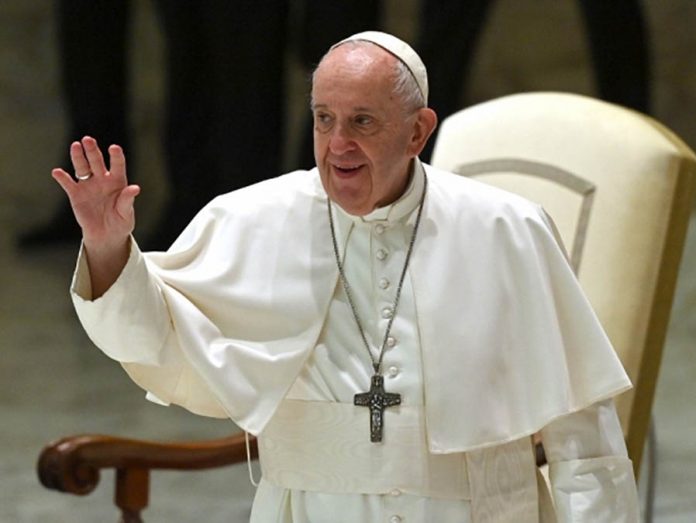 Pope Francis waves during his weekly general audience in the Paul VI hall at the Vatican on Oct. 14, 2020. ALBERTO PIZZOLI/AFP