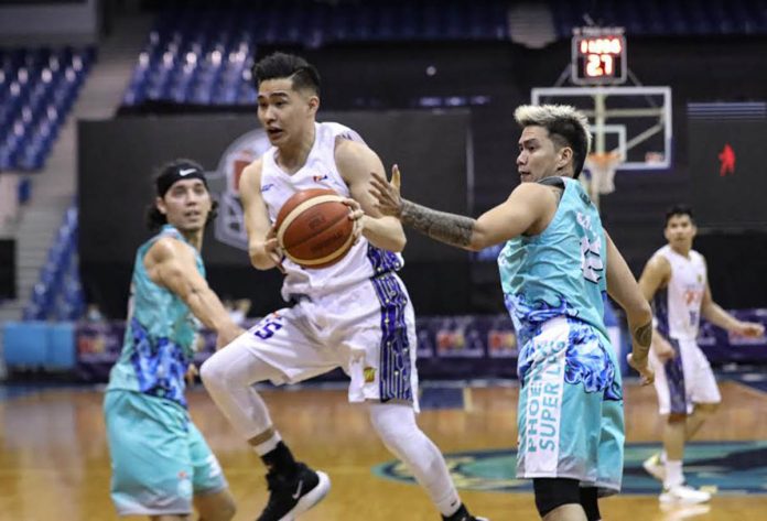 Bacolodnon Kib Montalbo of TNT Tropang Giga handles the ball as Ryan Roose Garcia of Phoenix Super LPG Fuel Masters attempts to swipe it. PBA PHOTO