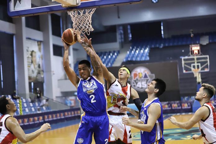 NLEX Road Warriors’ Michael Miranda beats San Miguel Beermen’s Arwind Santos for a rebound. PBA PHOTO