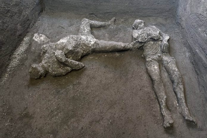 The casts of what are believed to have been a rich man and his male slave fleeing the volcanic eruption of Vesuvius nearly 2,000 years ago, are seen at a villa in the outskirts of the ancient Roman city of Pompeii destroyed by the eruption in 79 A.D. PARCO ARCHEOLOGICO DI POMPEI VIA AP