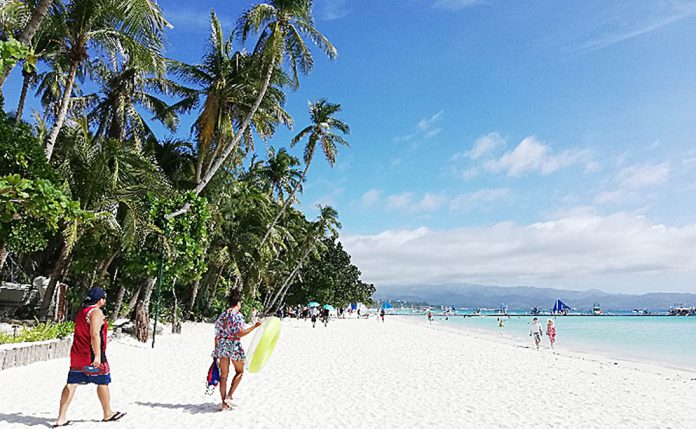 Boracay’s white sand beach and turquoise water glisten under the bright sun prior to the coronavirus disease pandemic. The island resort reopened to domestic travelers on Oct. 1, 2020. PNA PHOTO