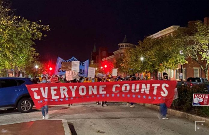 Activists march along State Street in front of the Pennsylvania State Capitol Building to protest attempts to halt the counting of ballots cast in the state for the 2020 presidential election. NATHAN LAYNE/REUTERS