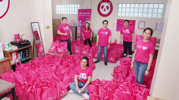 Employees of foodpanda prepare special gift packs ahead of Christmas Day.